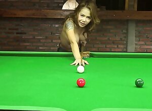 Inked beauty Kate bends over the billiard table to show off some curves